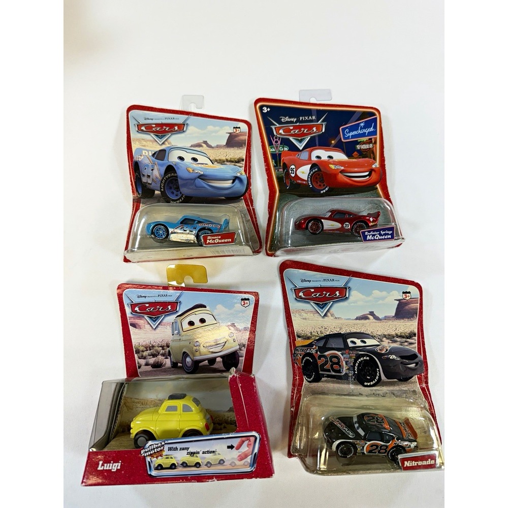Lot of 4 Disney Pixar Cars Sealed Dinoco McQueen Radiator Springs Nitroade Luigi